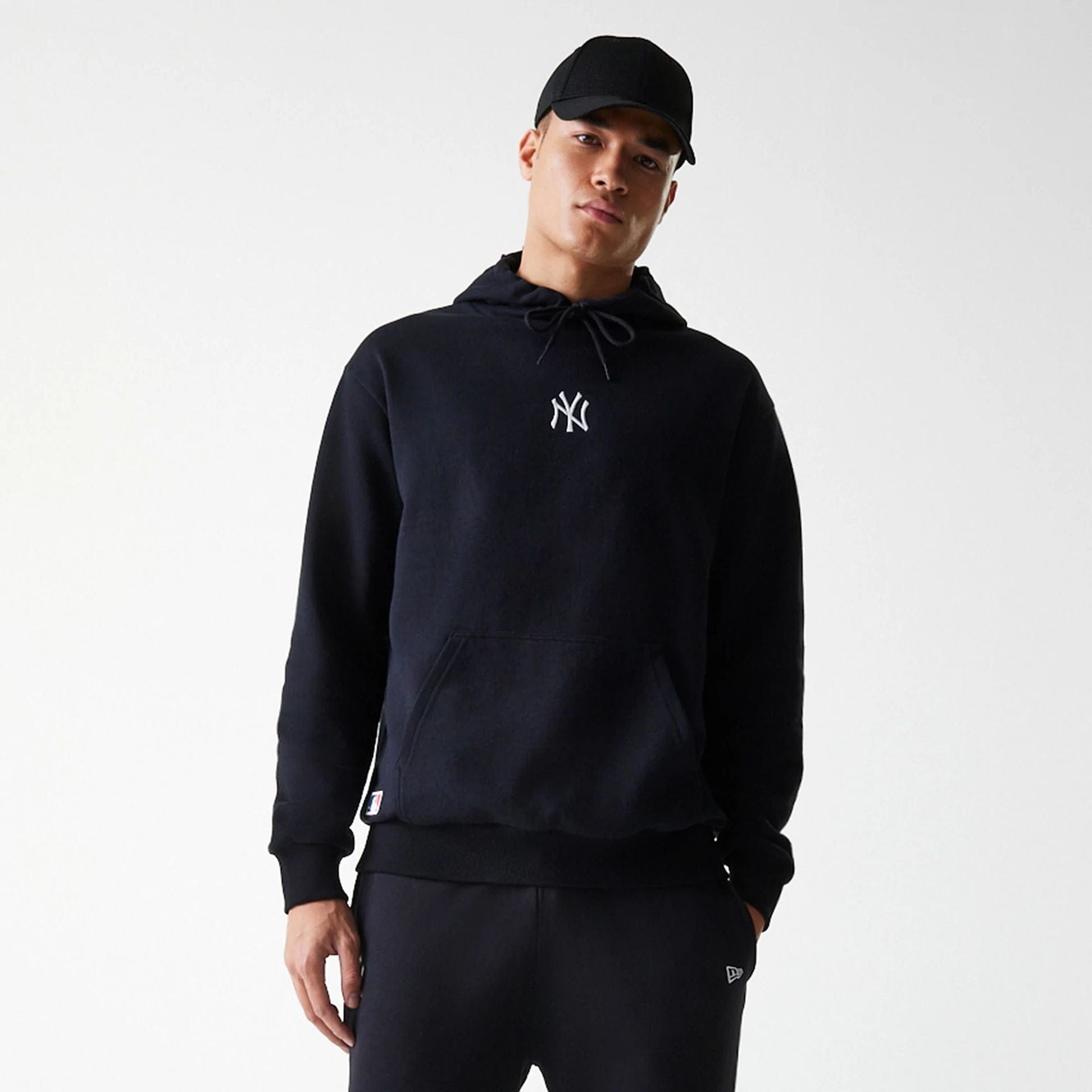 The Male model is wearing New York Yankees MLB League Essential Midi Black Oversized Pullover Hoodie 3