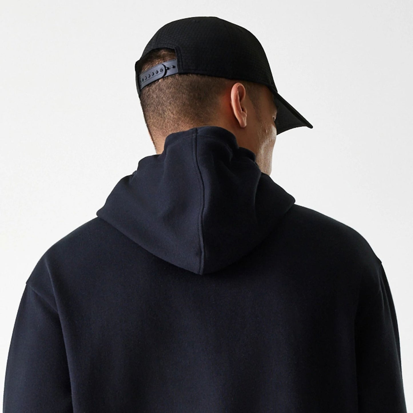 The Male model is wearing New York Yankees MLB League Essential Midi Black Oversized Pullover Hoodie 7