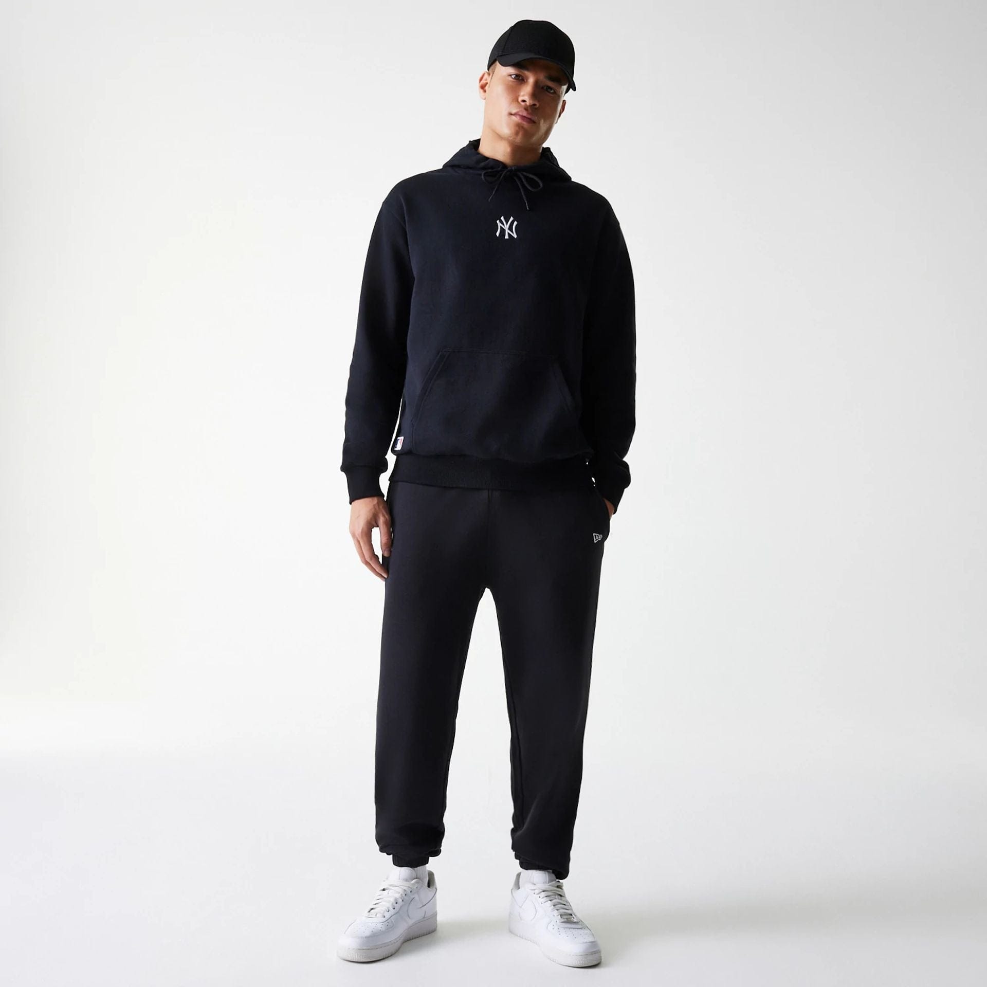 The Male model is wearing New York Yankees MLB League Essential Midi Black Oversized Pullover Hoodie 8