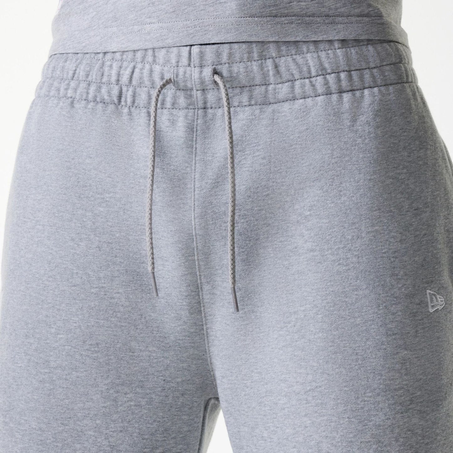 The Male model is wearing New York Yankees MLB League Essential Grey Shorts 6