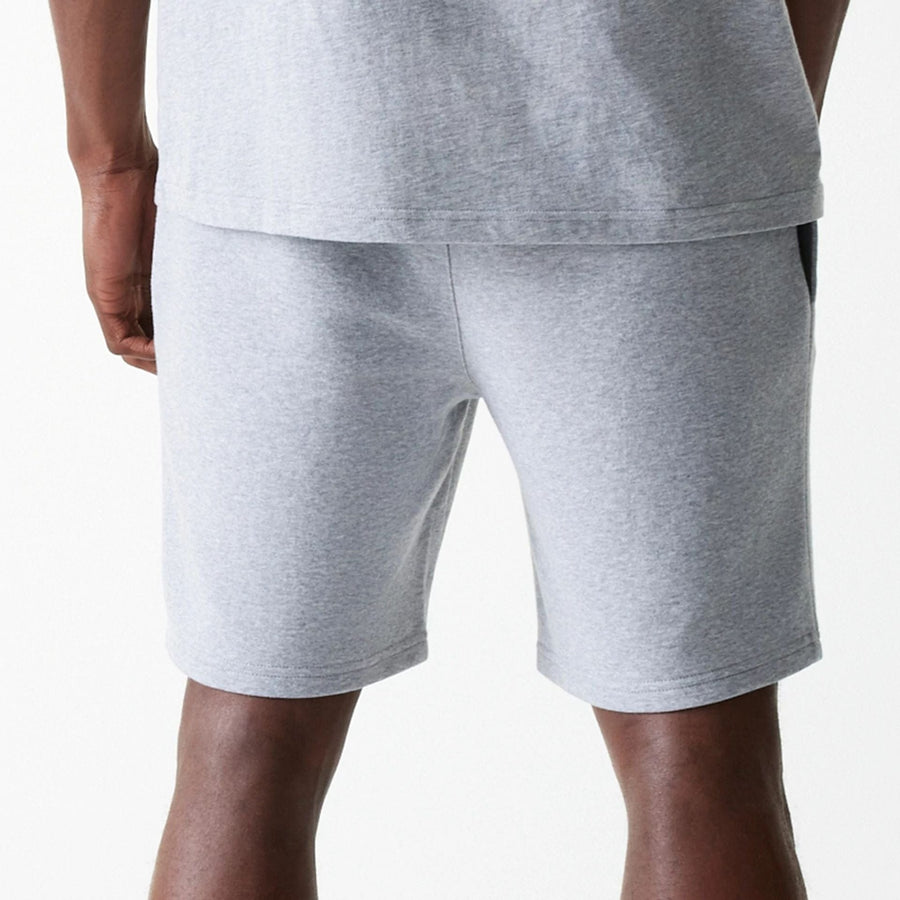 The Male model is wearing New York Yankees MLB League Essential Grey Shorts 7