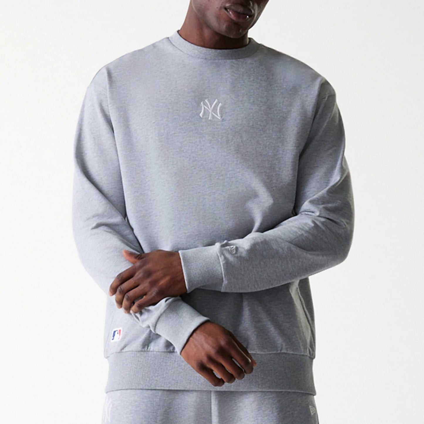 The Male model is wearing New York Yankees MLB League Essential Grey Crew Neck Sweater. 3