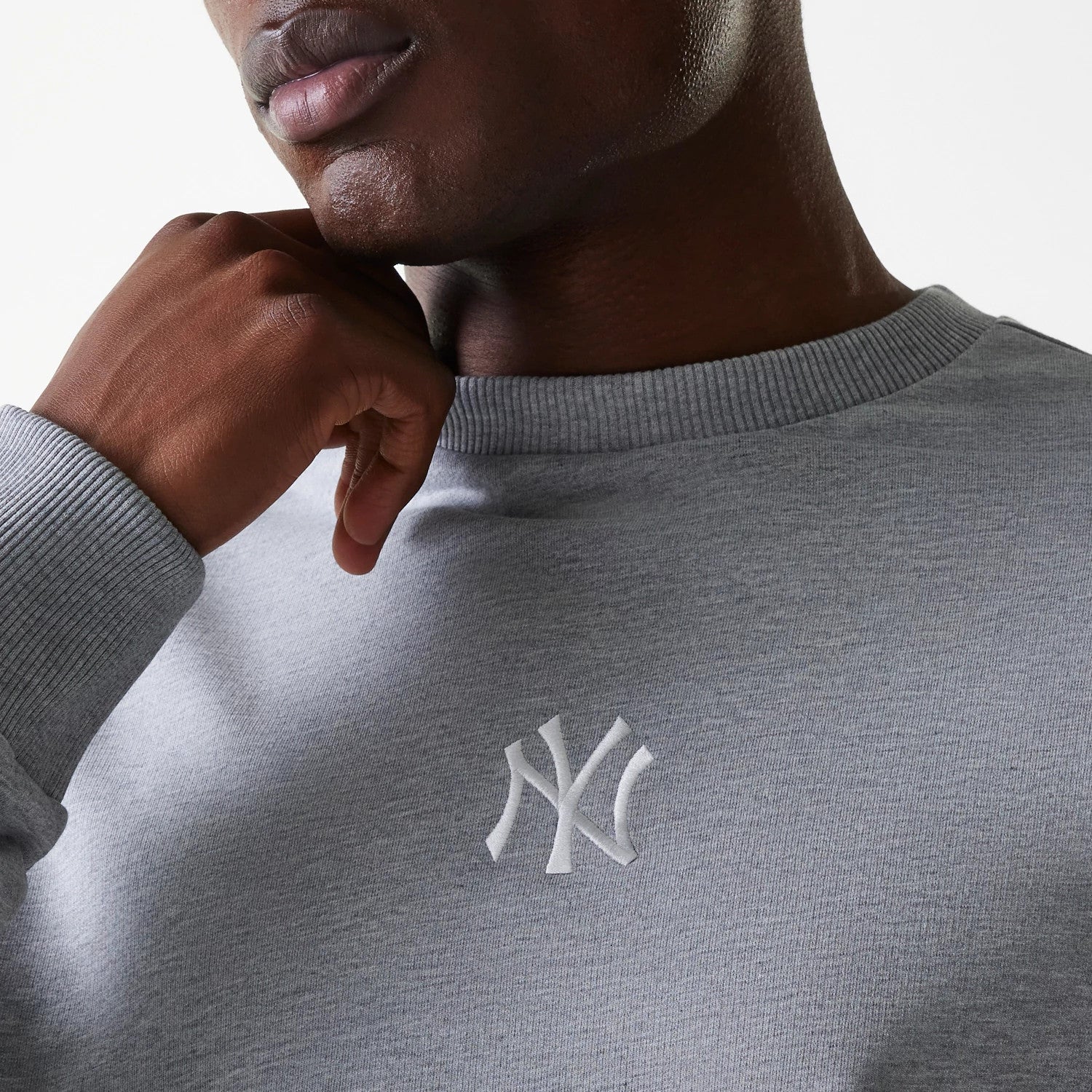 The Male model is wearing New York Yankees MLB League Essential Grey Crew Neck Sweater. 4
