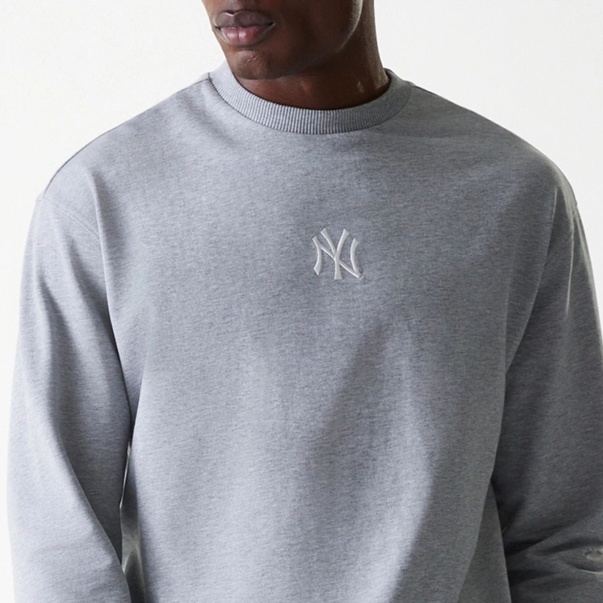 The Male model is wearing New York Yankees MLB League Essential Grey Crew Neck Sweater 6