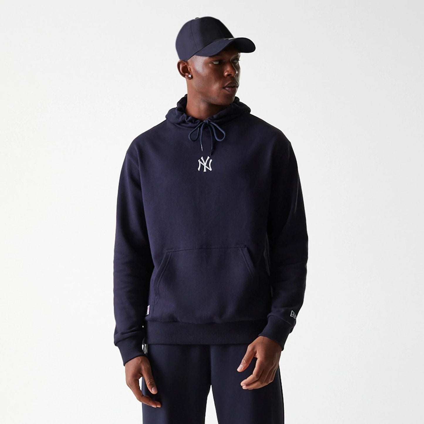 The Male model is wearing New York Yankees MLB League Essential Midi Navy Oversized Pullover Hoodie 3