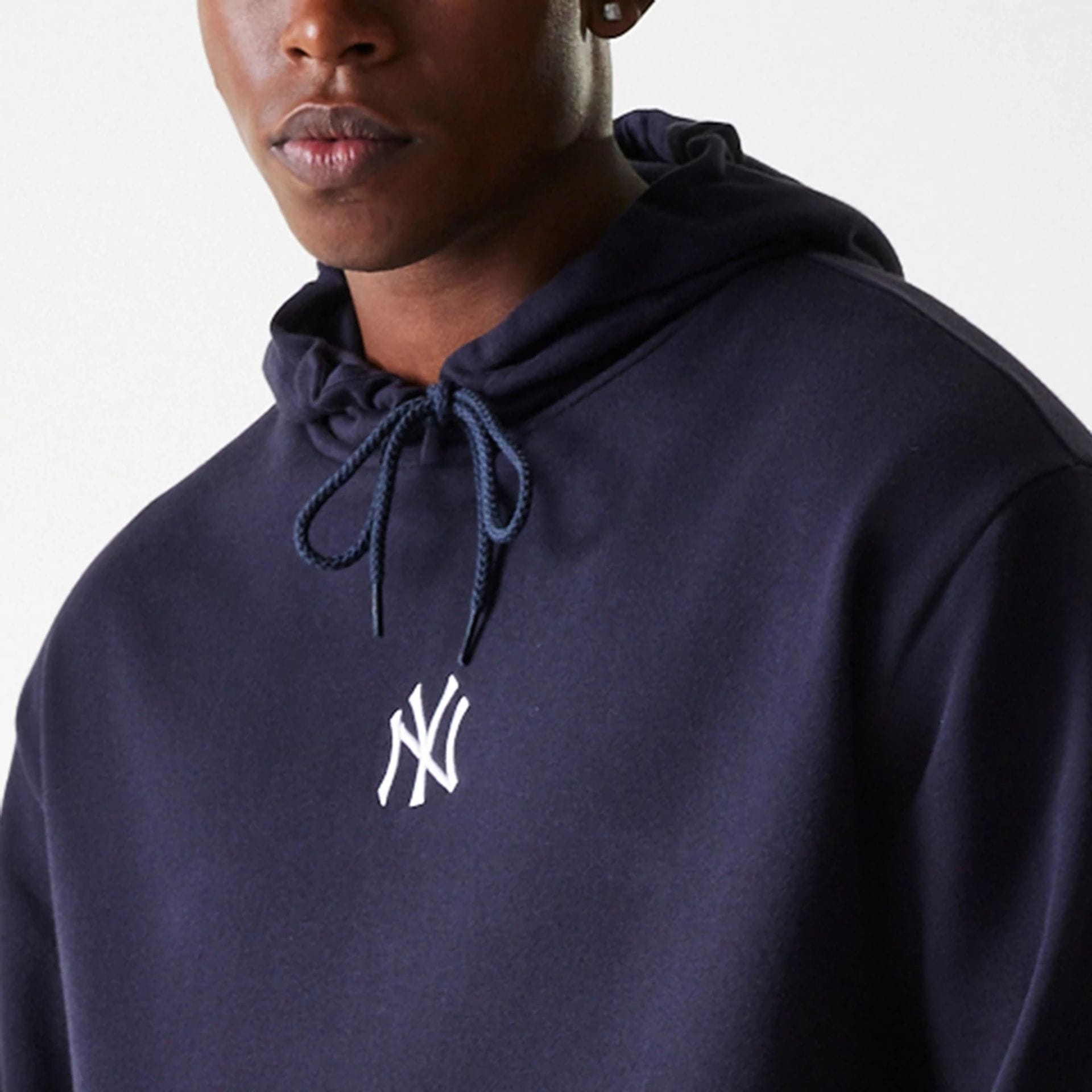 The Male model is wearing New York Yankees MLB League Essential Midi Navy Oversized Pullover Hoodie 4