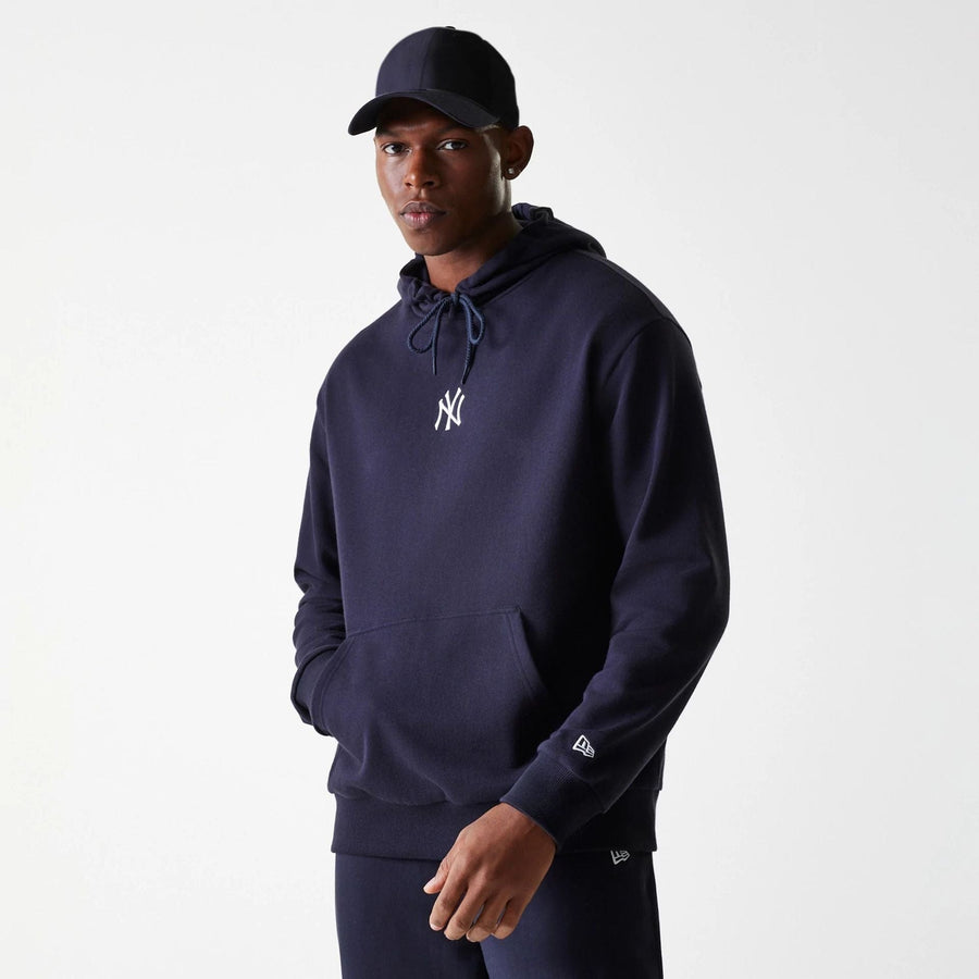 The Male model is wearing New York Yankees MLB League Essential Midi Navy Oversized Pullover Hoodie 1