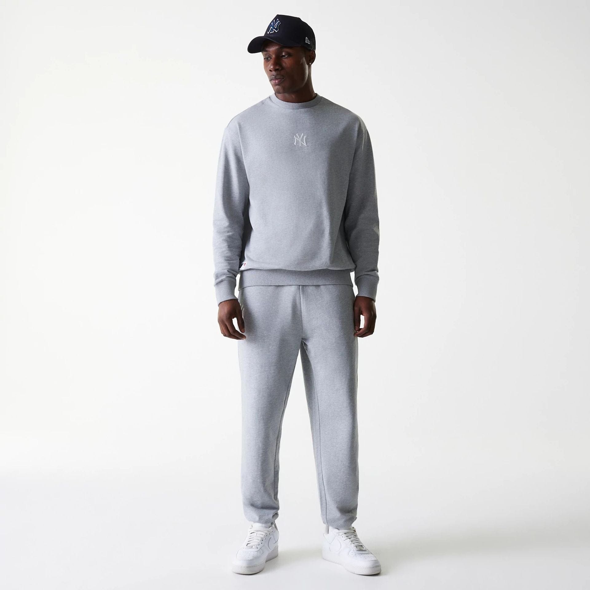 The Male model is wearing New York Yankees MLB League Essential Midi Grey Joggers 8