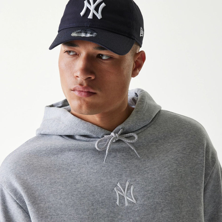 The Male model is wearing New York Yankees MLB League Essential Grey Oversized Pullover Hoodie 4