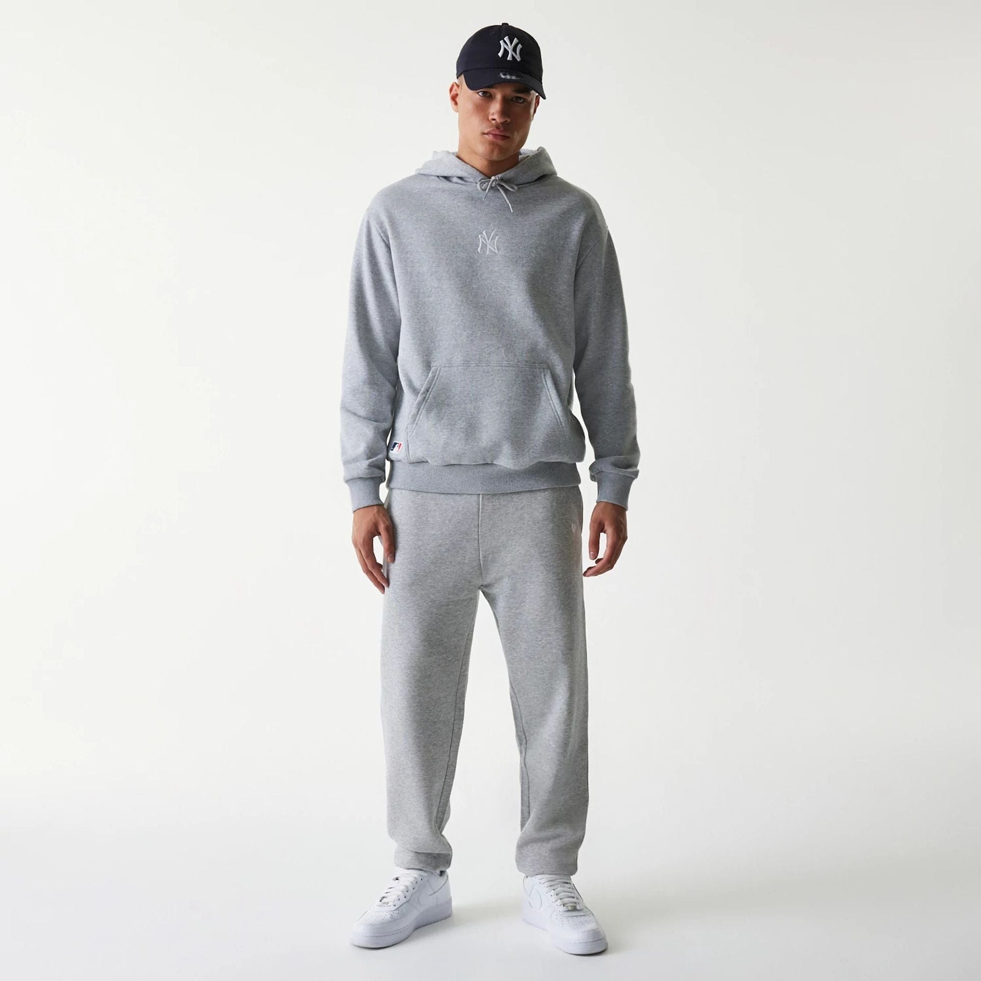 The Male model is wearing New York Yankees MLB League Essential Grey Oversized Pullover Hoodie 8