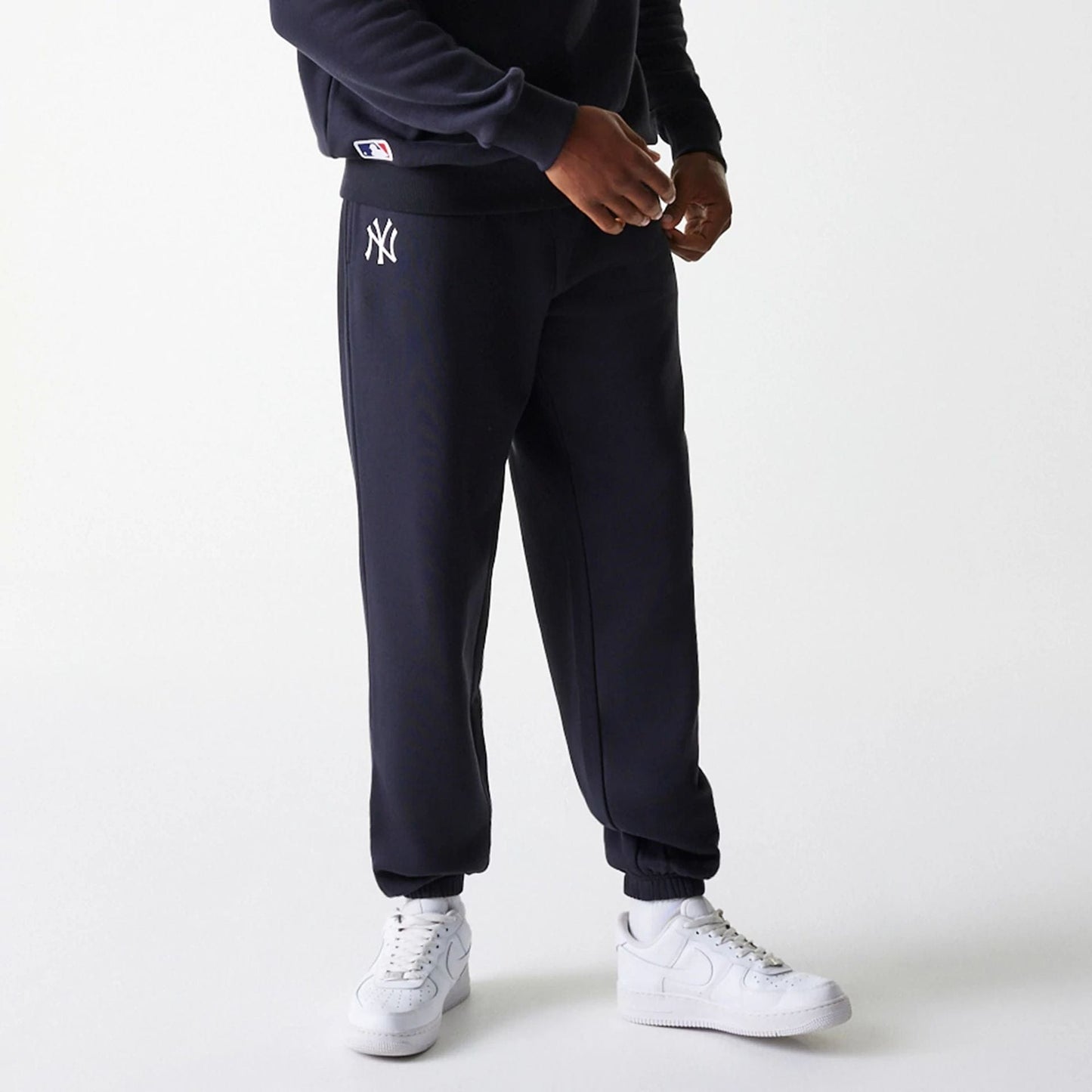 The Male model is wearing New York Yankees MLB League Essential Navy Joggers 1