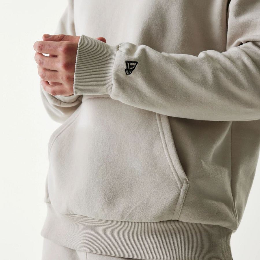 The Male model is wearing New York Yankees MLB League Essential Cream Oversized Pullover Hoodie 5