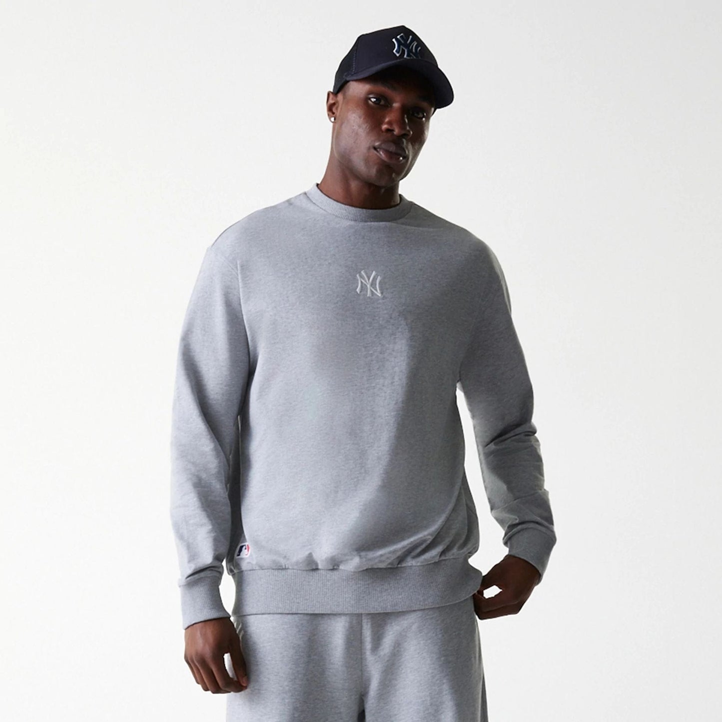 The Male model is wearing New York Yankees MLB League Essential Midi Grey Oversized Crew Neck Sweater 3