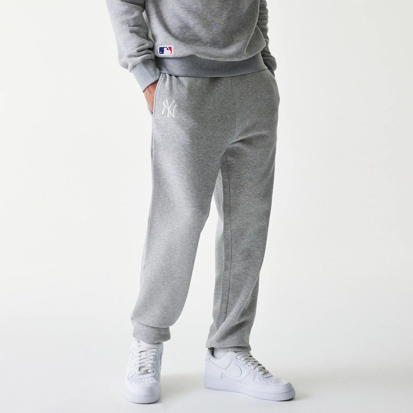 The Male model is wearing New York Yankees MLB League Essential Grey Joggers 1