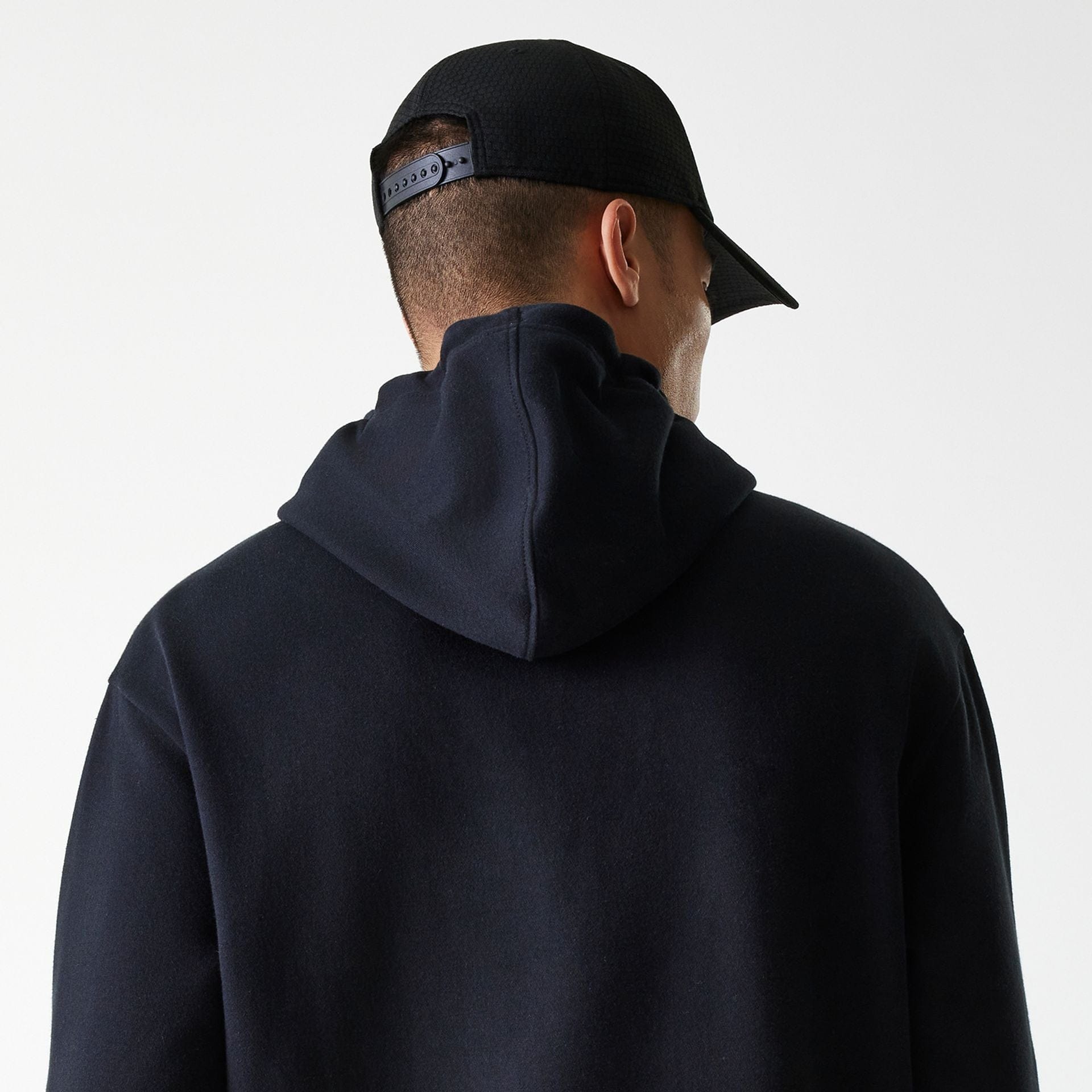 The Male model is wearing New York Yankees MLB League Essential Black Oversized Pullover Hoodie 6