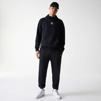 The Male model is wearing New York Yankees MLB League Essential Black Oversized Pullover Hoodie 7