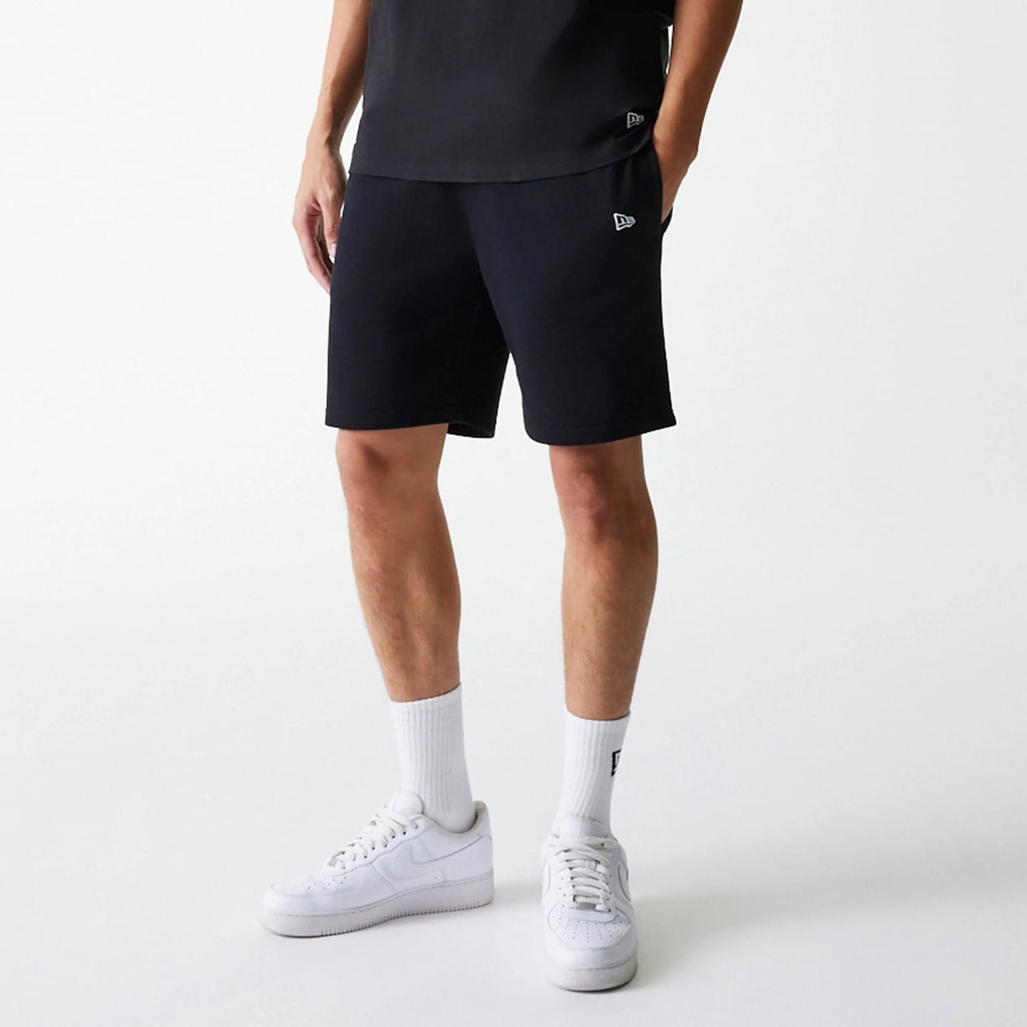 The Male model is wearing New York Yankees MLB League Essential Midi Black Shorts 3