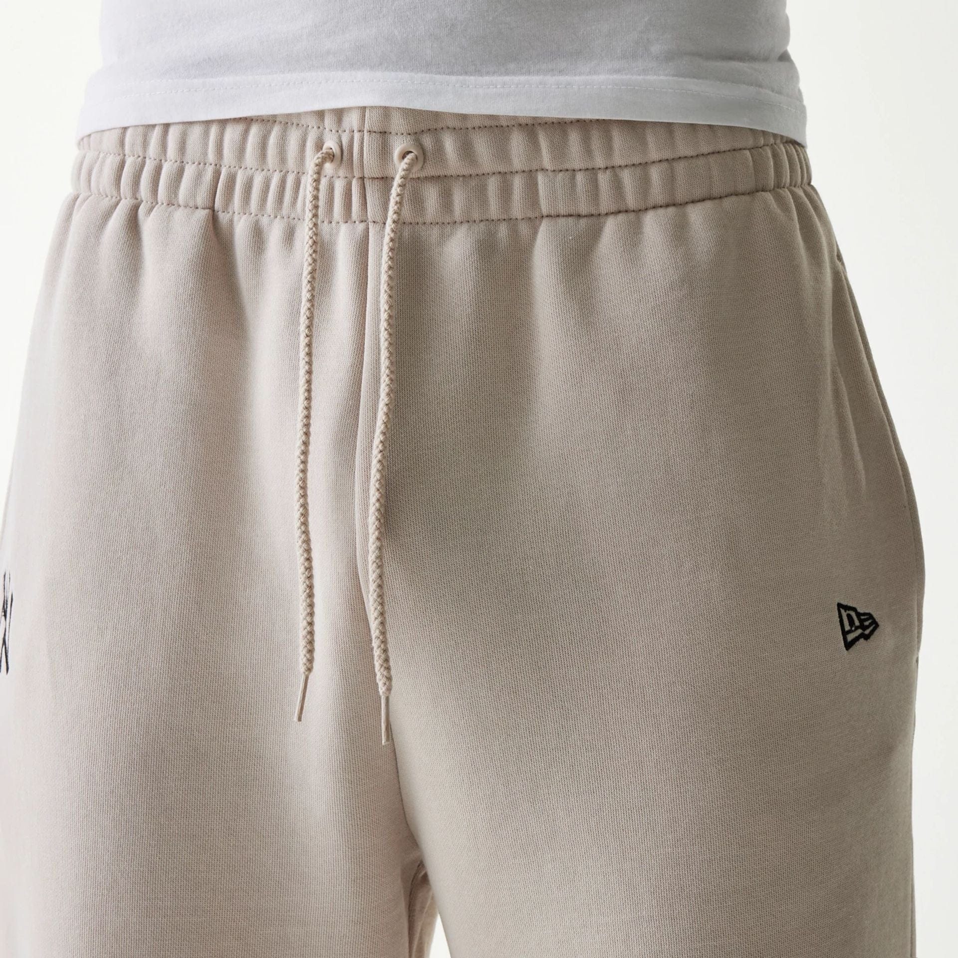 The Male model is wearing New York Yankees MLB League Essential Cream Joggers 3