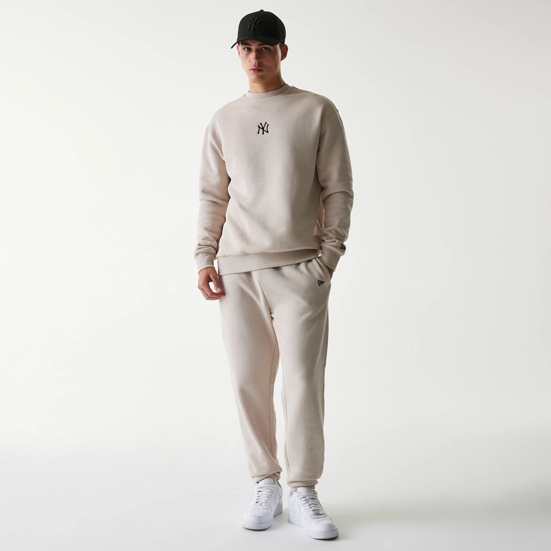 The Male model is wearing New York Yankees MLB League Essential Cream Joggers 8