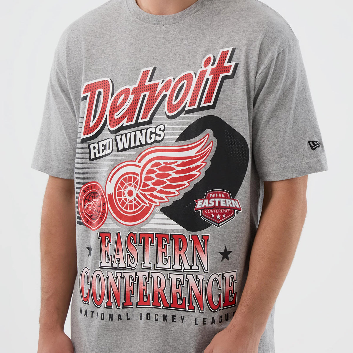 New Era Detroit Red Wings NHL Sport Classic Grey T-Shirt, front view showing large red and white graphics with the team's logo and text on the grey fabric, a small black raised New Era logo on the left sleeve.