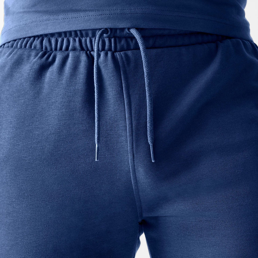 The Male model is wearing LA Dodgers MLB Midi League Essential Dark Blue Shorts 6