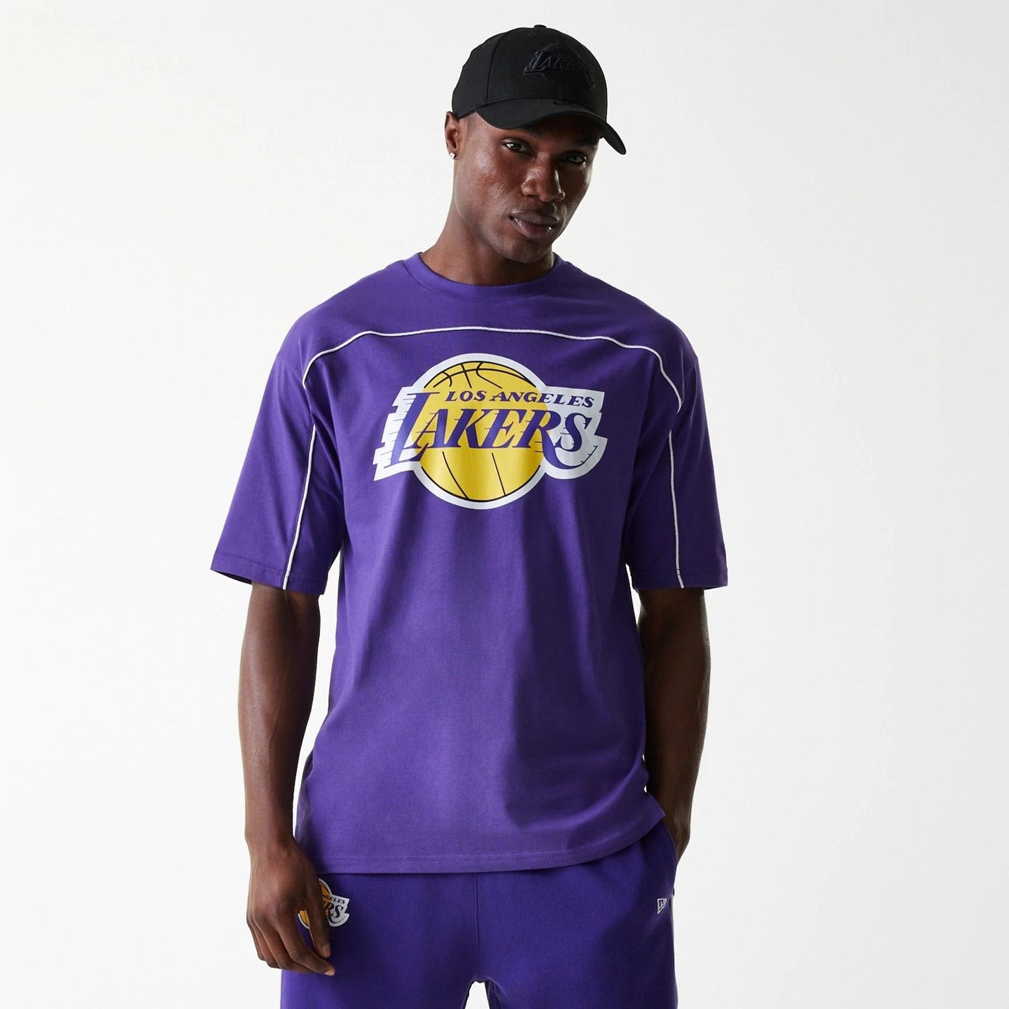 The Male model is wearing LA Lakers NBA Piping Purple Oversized T-Shirt 1