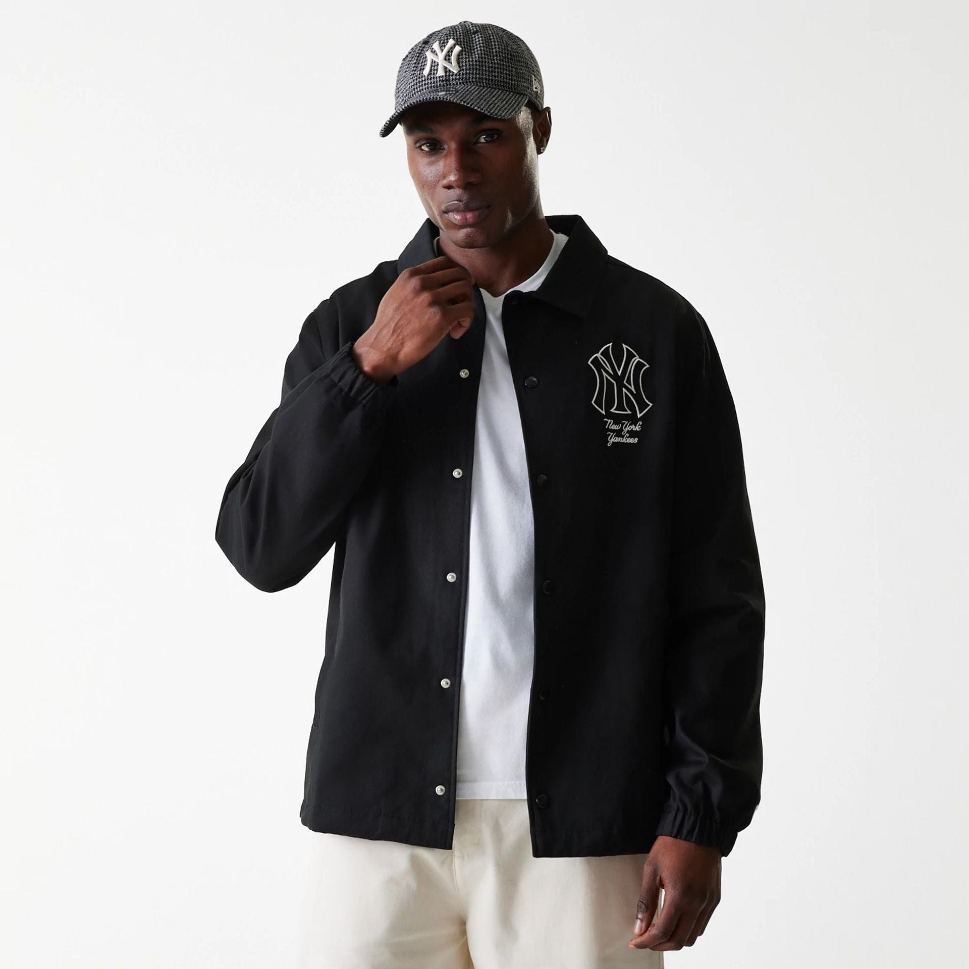 The Male model is wearing New York Yankees MLB Twill Black Coaches Jacket 3
