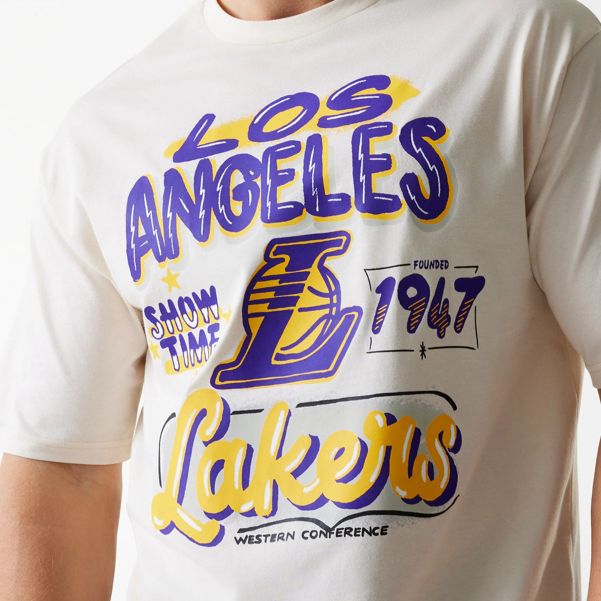 New Era LA Lakers NBA Graphic Light Beige Oversized T-Shirt, front view showing the vibrant purple and yellow Los Angeles Lakers graphics with Showtime, Founded 1947, and Western Conference text on a light beige background.