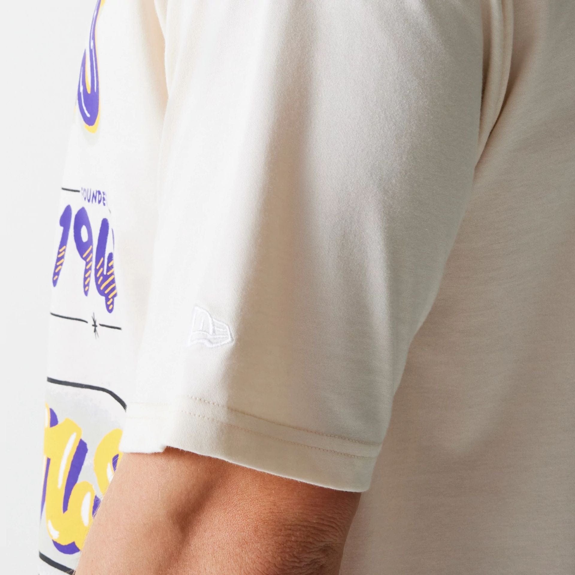 The Male model is wearing LA Lakers NBA Graphic Light Beige Oversized T-Shirt 5