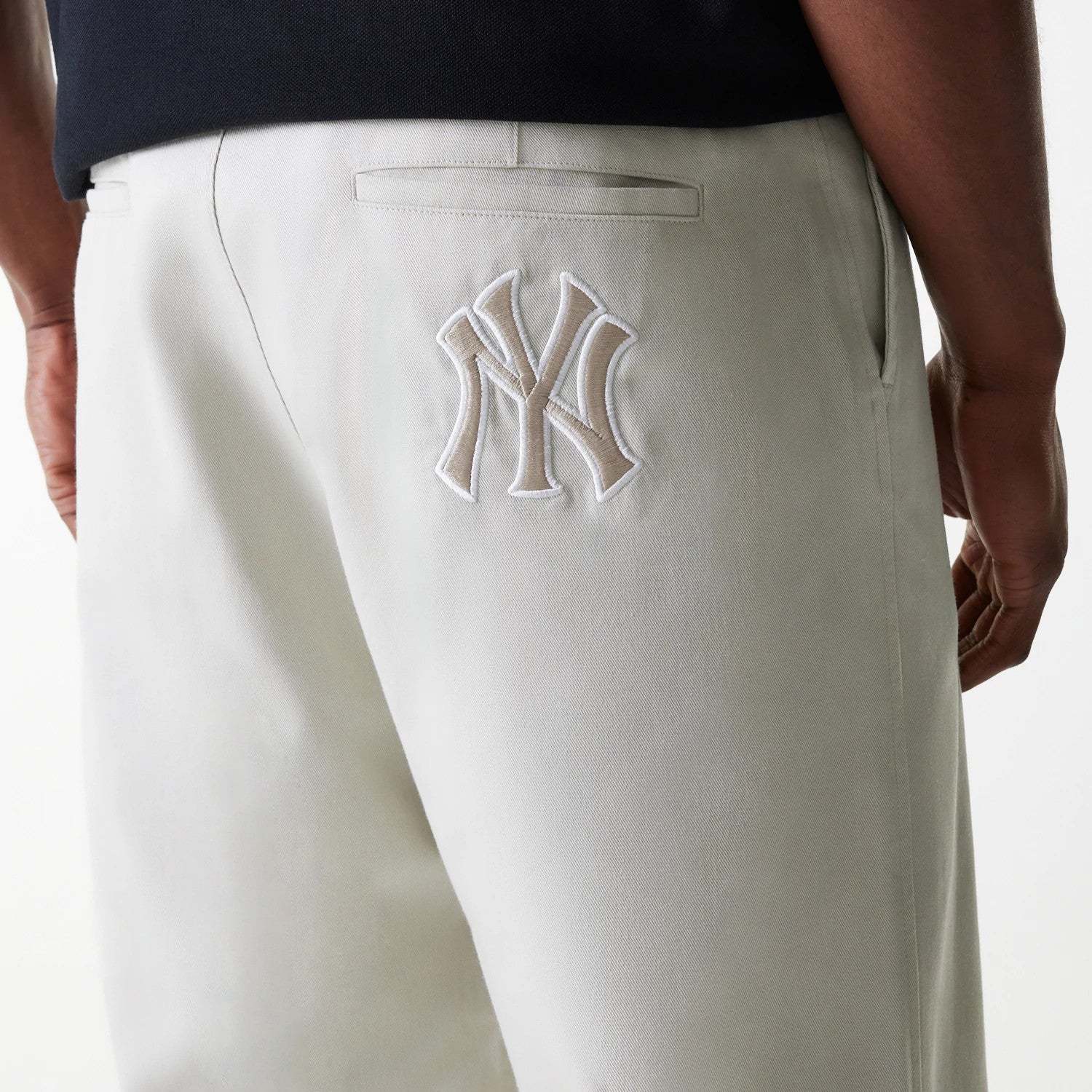 The Male model is wearing New York Yankees MLB Light Beige Chino Trousers 4