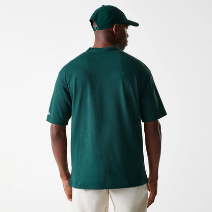 New Era Detroit Tigers MLB Heritage Dark Green Oversized T-Shirt, rear view showing the plain dark green back with short sleeves, a small New Era logo embroidered in white on the left sleeve, paired with a matching dark green cap.
