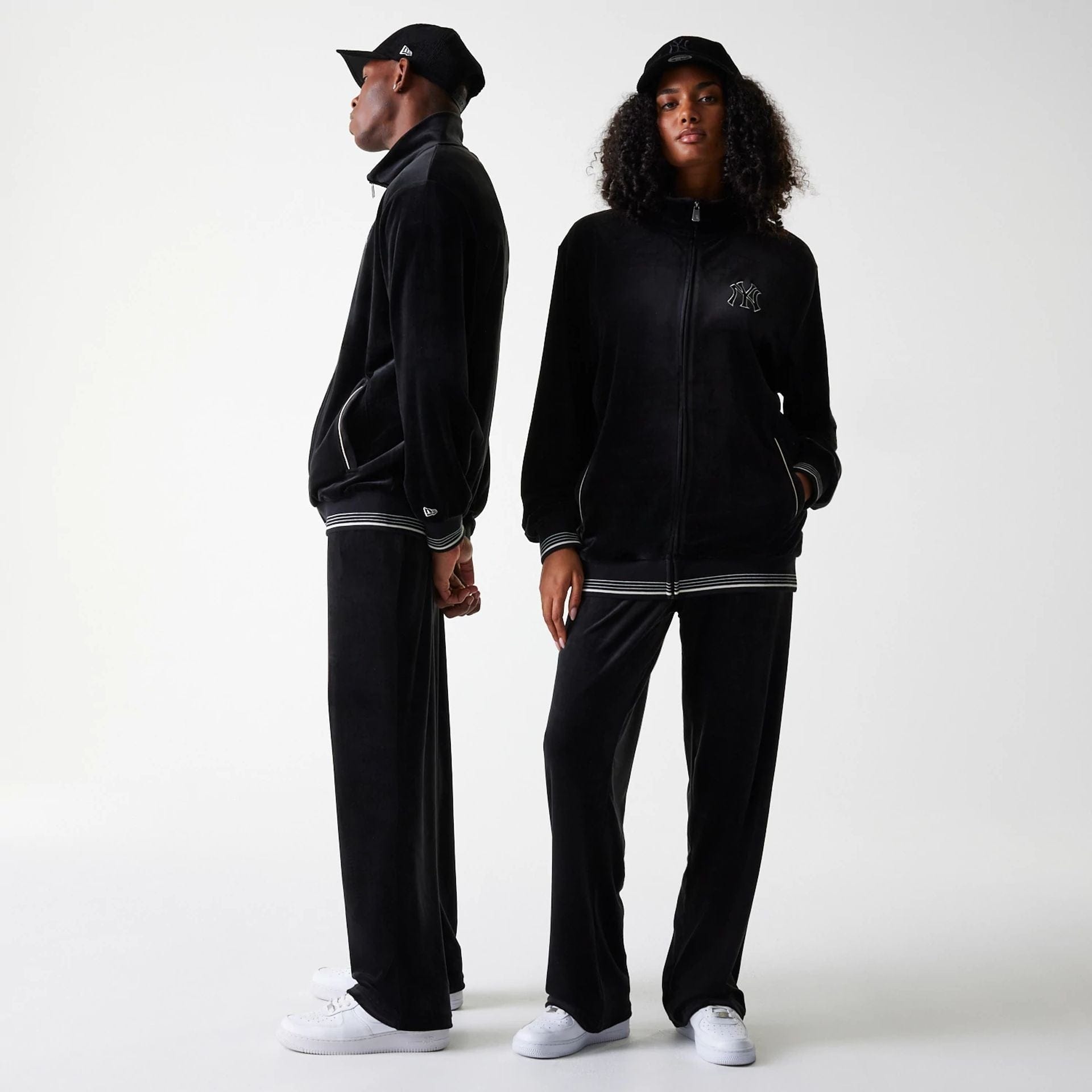 The Male model is wearing New York Yankees MLB Velour Black Track Pants 1