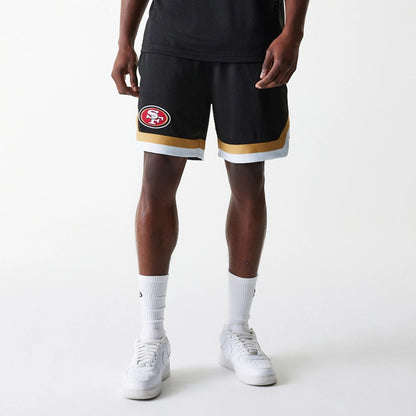 The Male model is wearing San Francisco 49ers NFL Mesh Black Shorts 7