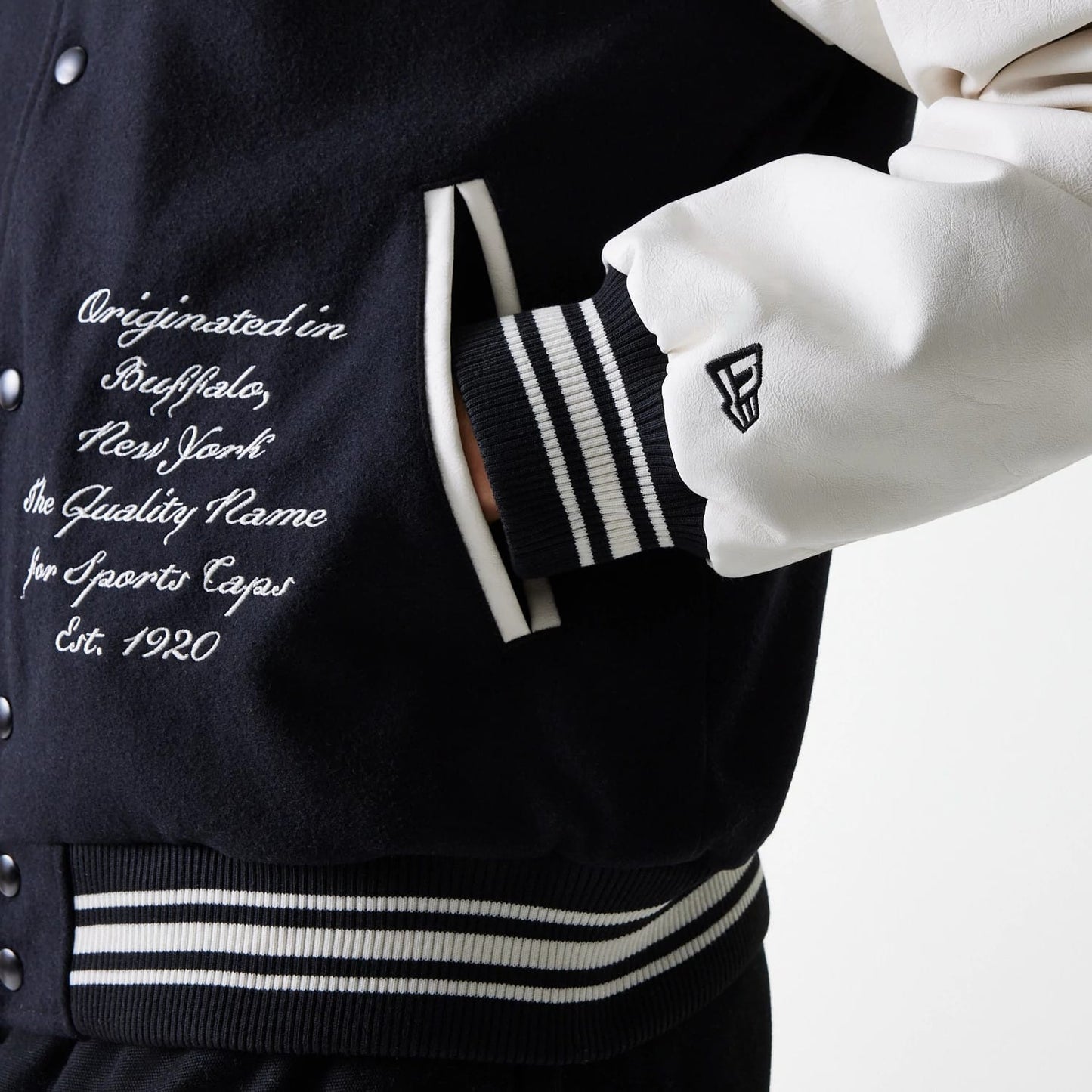The Male model is wearing New Era Patch Black Varsity Jacket 6