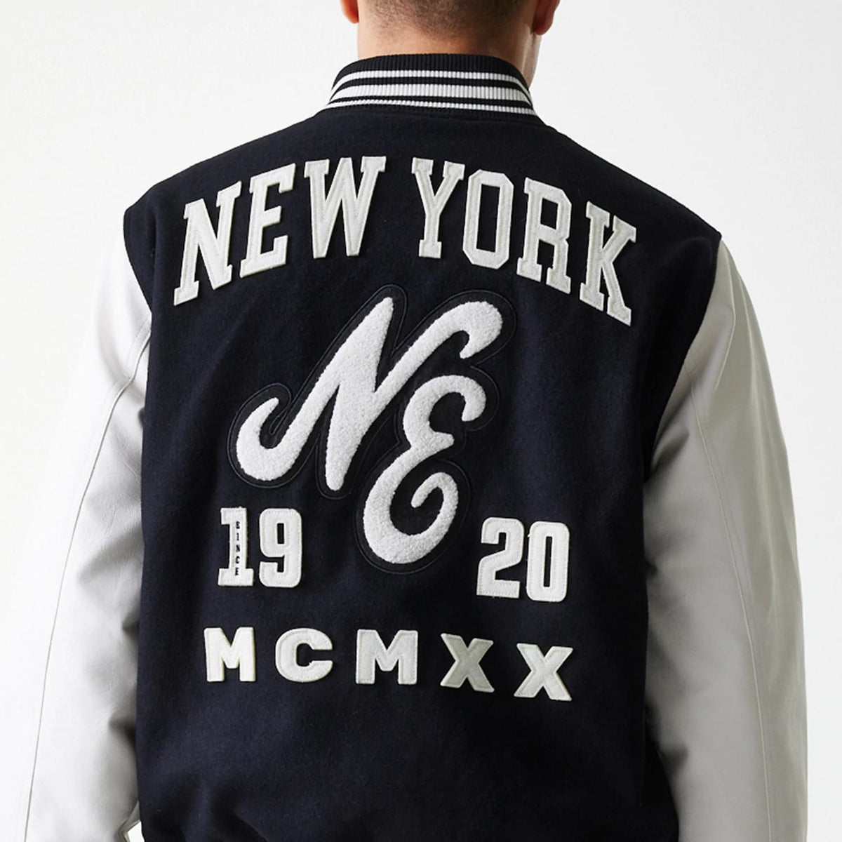 The Male model is wearing New Era Patch Black Varsity Jacket 7