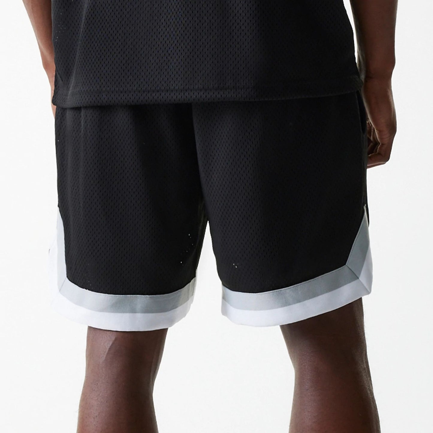 The Male model is wearing Las Vegas Raiders NFL Mesh Black Shorts 6