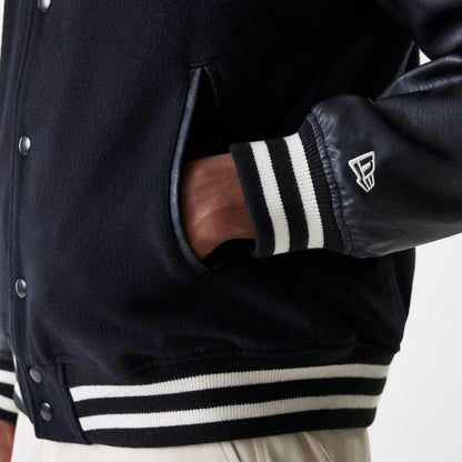 The Male model is wearing New Era Black Hooded Varsity Jacket 5