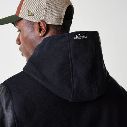 The Male model is wearing New Era Black Hooded Varsity Jacket 6