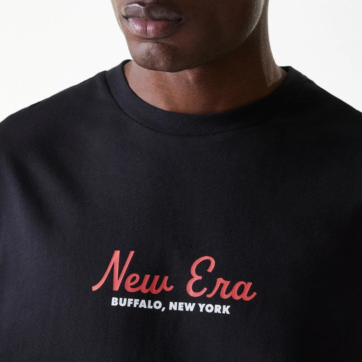 New Era Animal Graphic Black Oversized T-Shirt, front view featuring a large red and white embossed New Era logo with BUFFALO, NEW YORK text below, centred on the chest of the oversized black t-shirt.