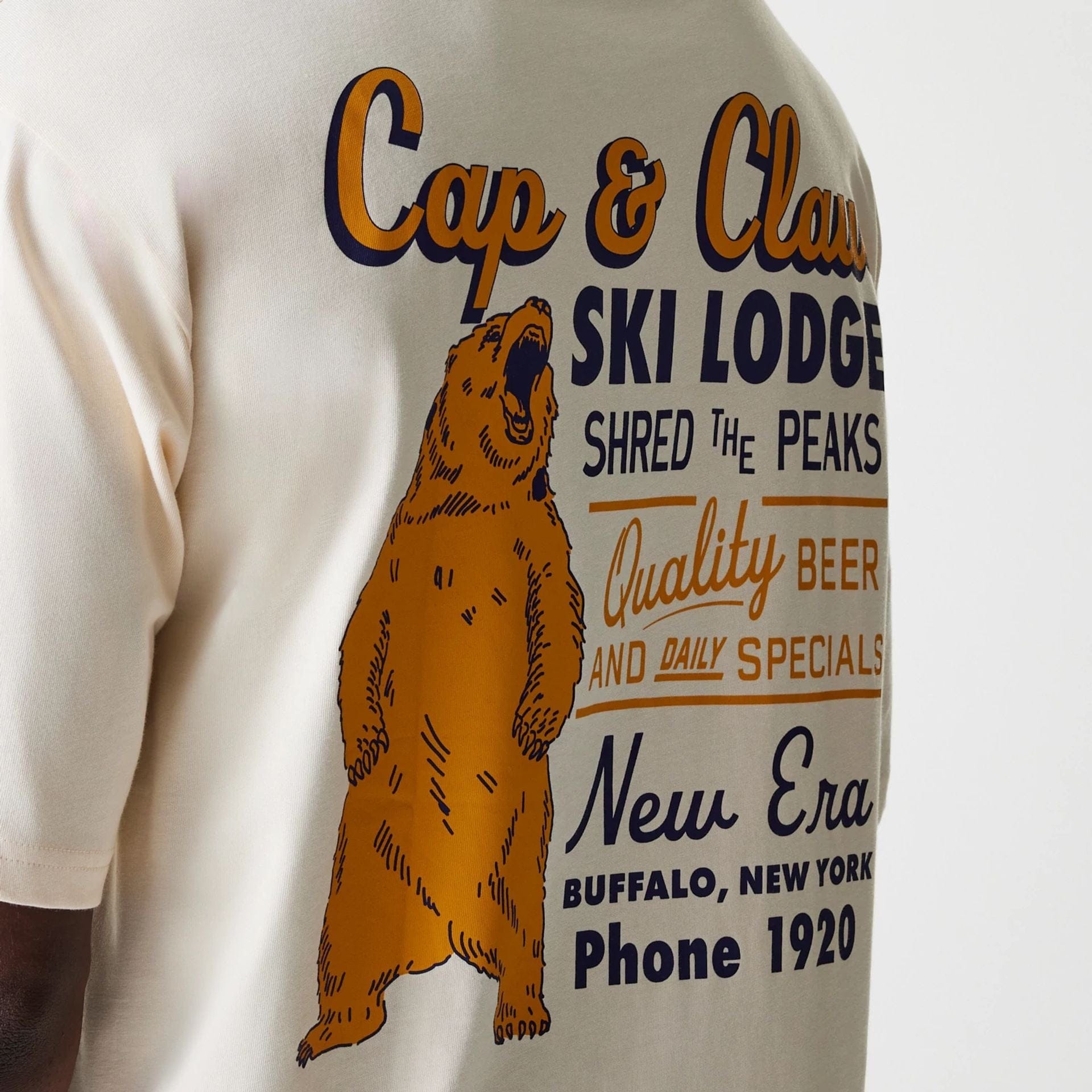 The Male model is wearing New Era Animal Graphic Light Beige Oversized T-Shirt 6