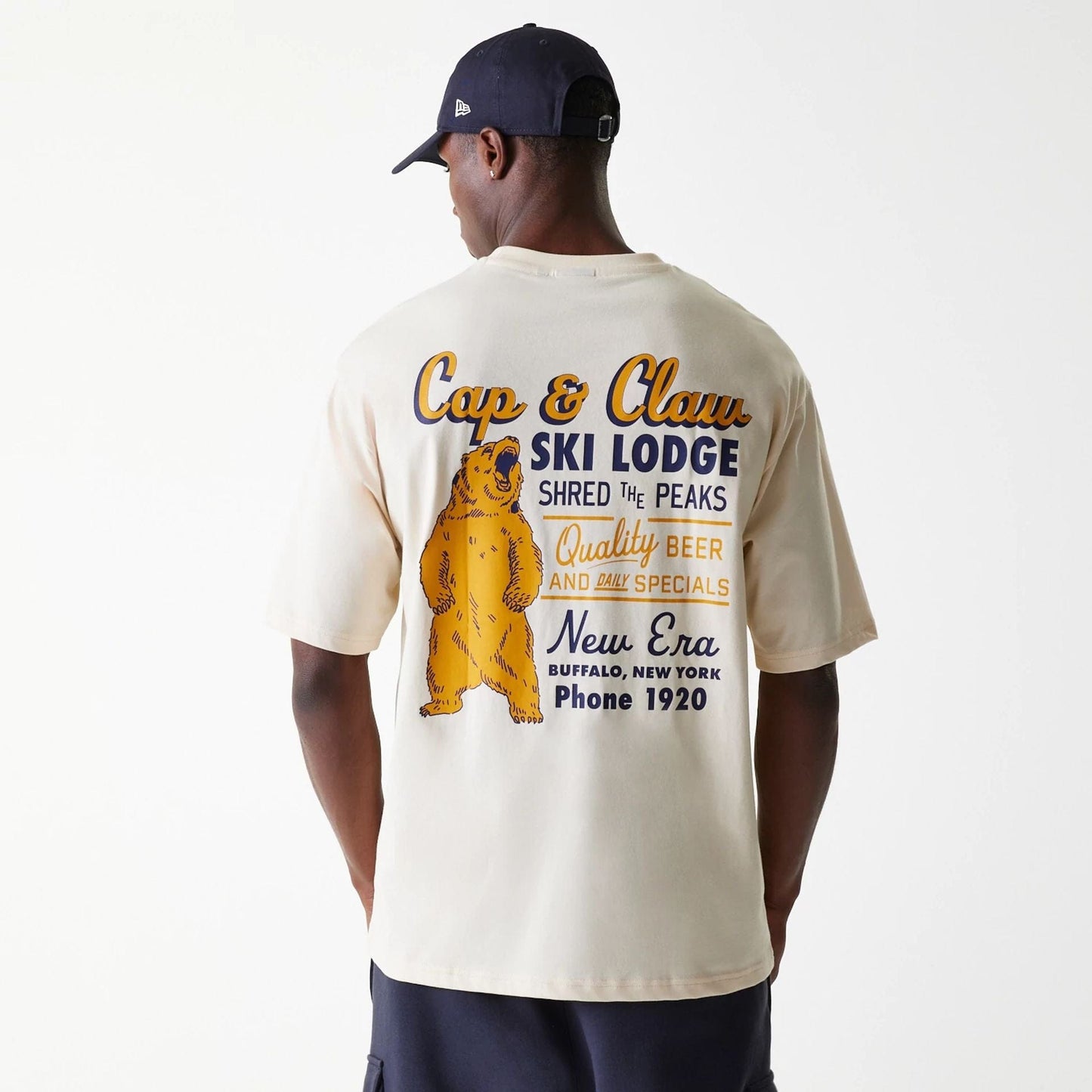 The Male model is wearing New Era Animal Graphic Light Beige Oversized T-Shirt 2