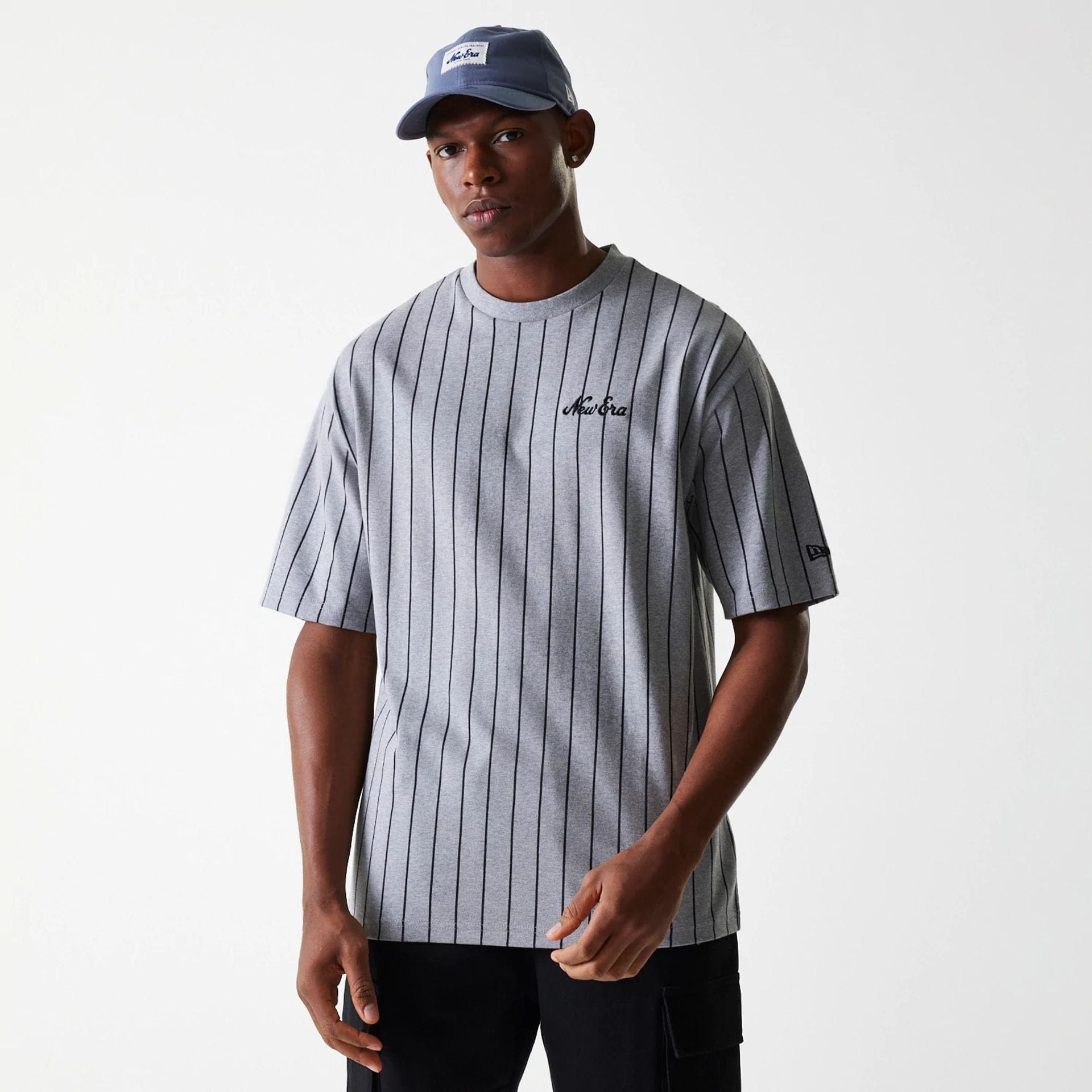 The Male model is wearing New Era Pinstripe Pastel Grey Oversized T-Shirt 1