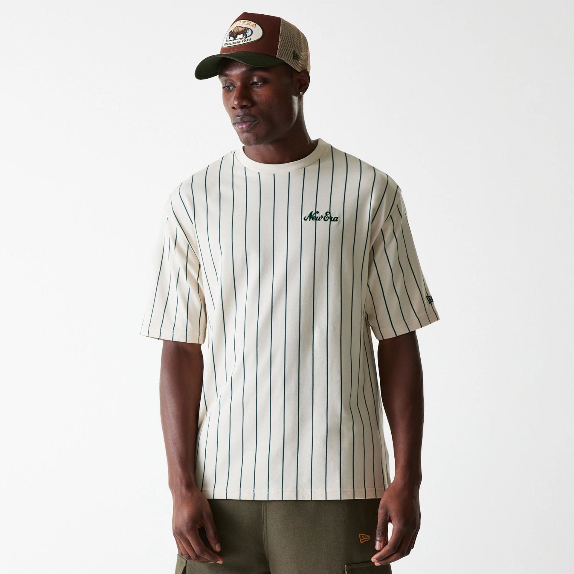 The Male model is wearing New Era Pinstripe Light Beige Oversized T-Shirt 1
