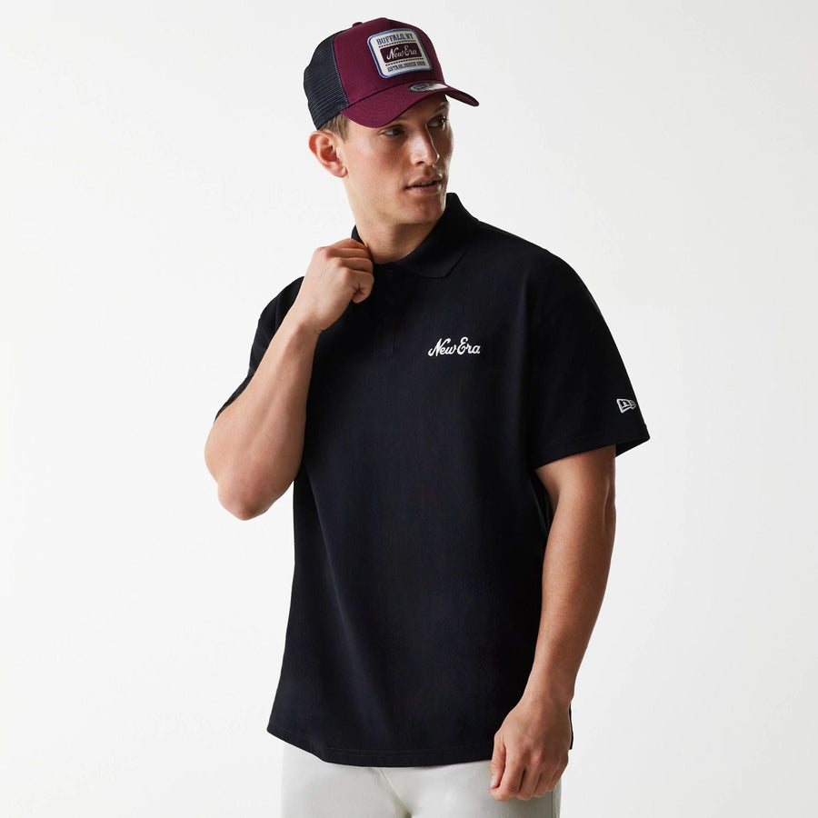 The Male model is wearing New Era Script Black Polo T-Shirt 1