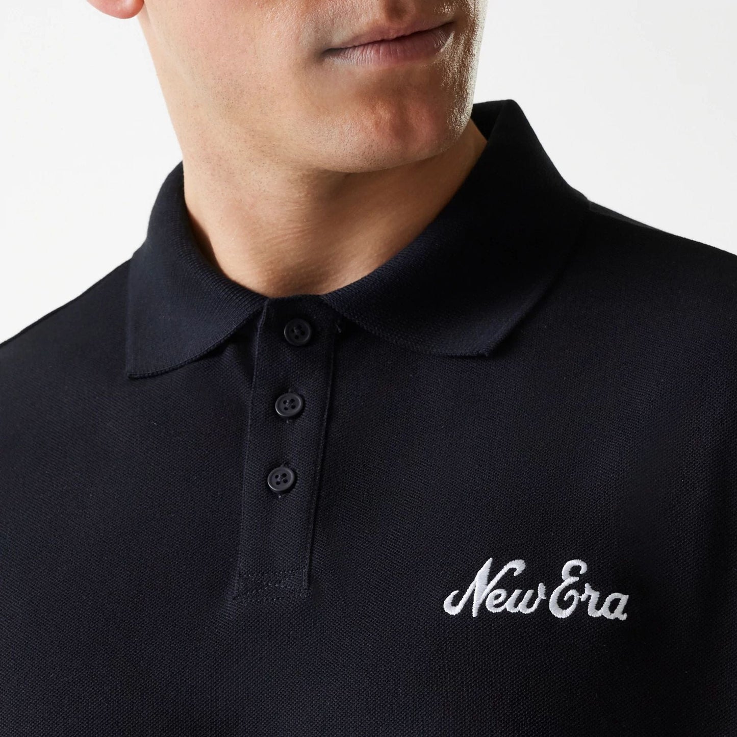 The Male model is wearing New Era Script Black Polo T-Shirt 4