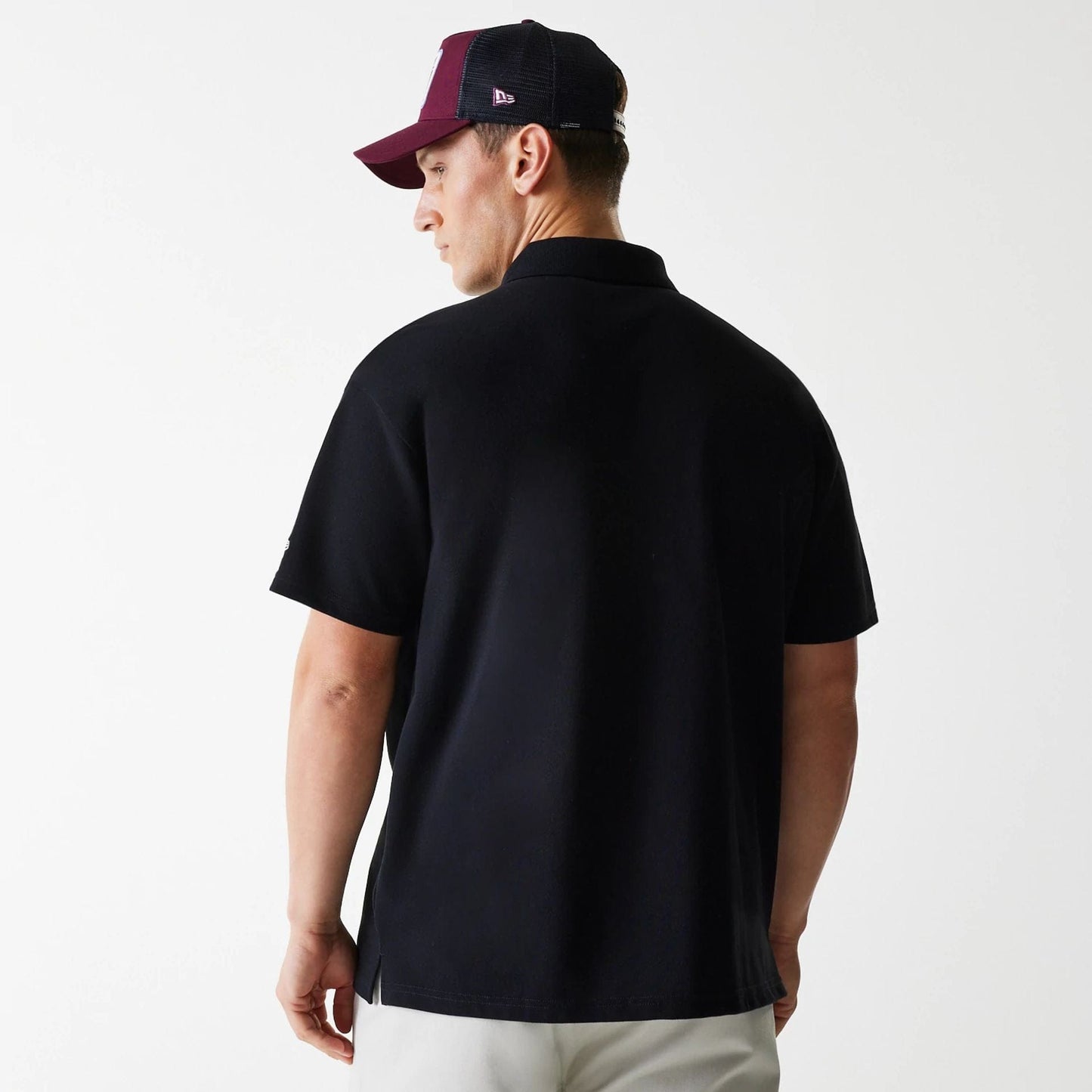 The Male model is wearing New Era Script Black Polo T-Shirt 2