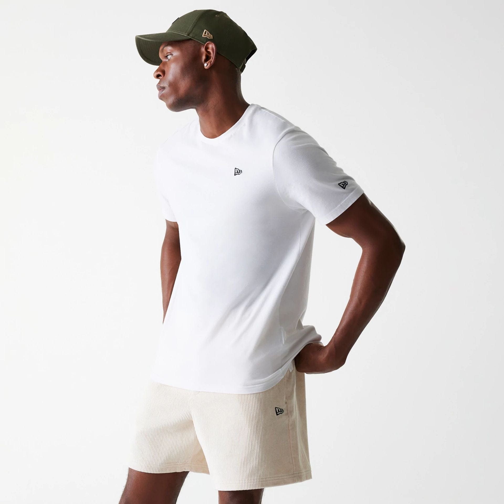 The Male model is wearing New Era Cord Light Beige Shorts 1