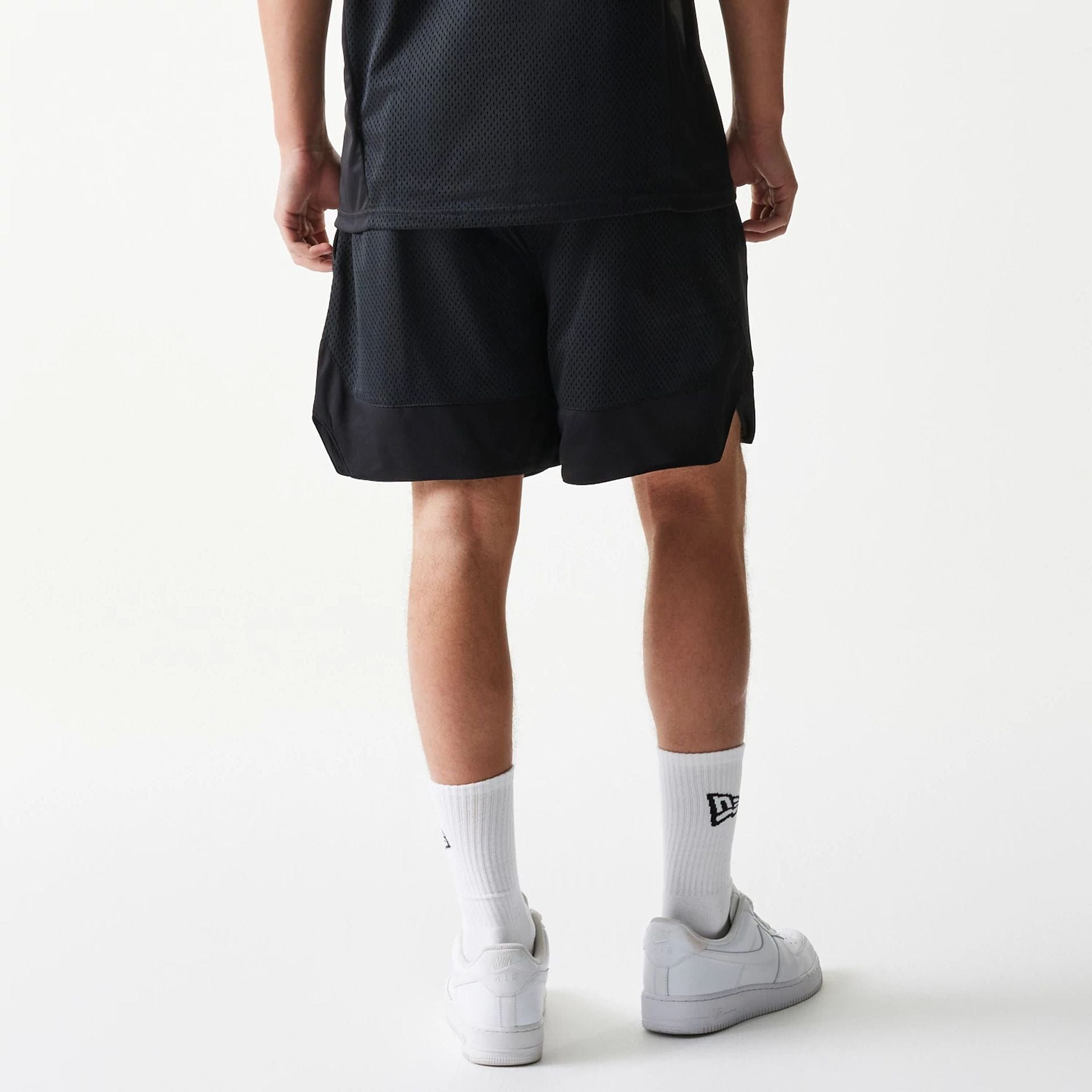 The Male model is wearing New Era Mesh Black Shorts 2