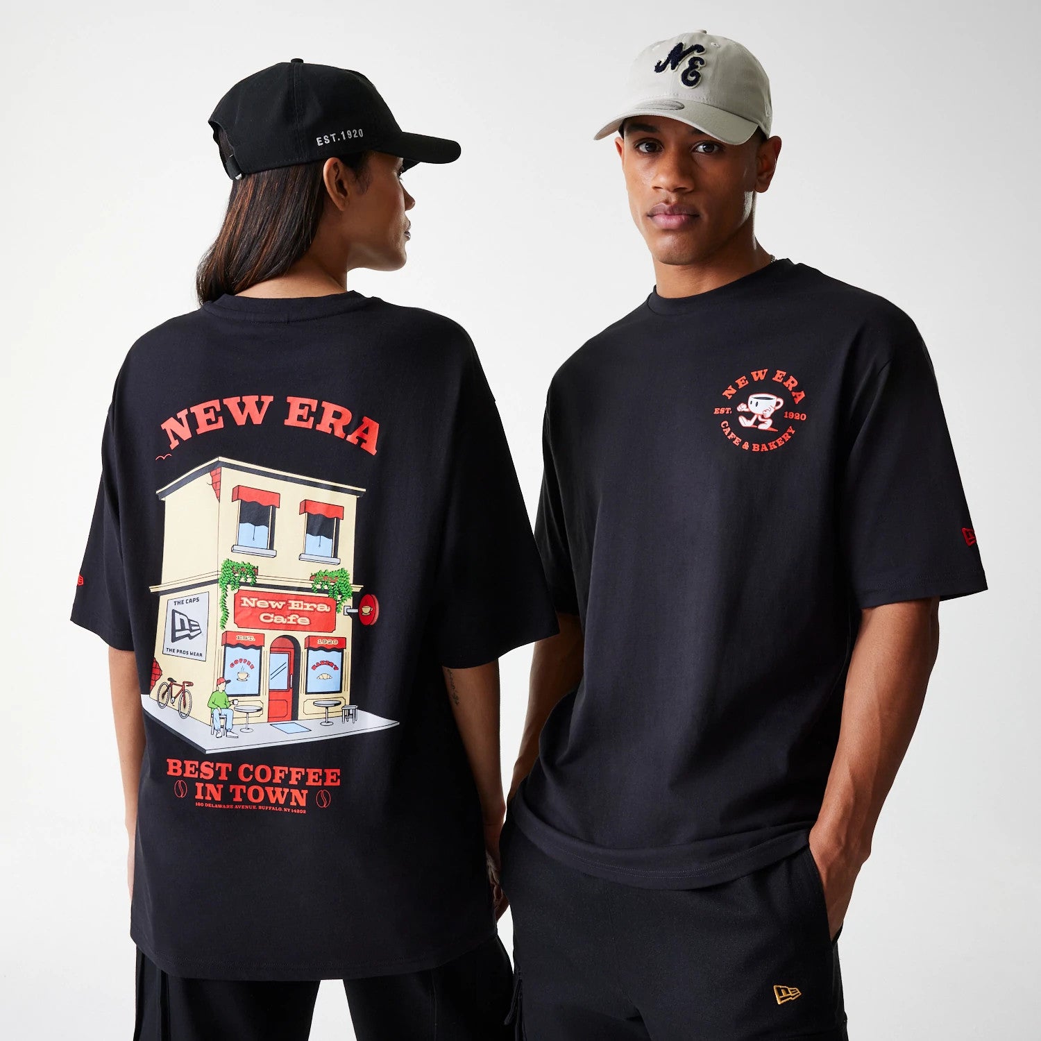 The Male model is wearing New Era Cafe Graphic Black Oversized T-Shirt 1