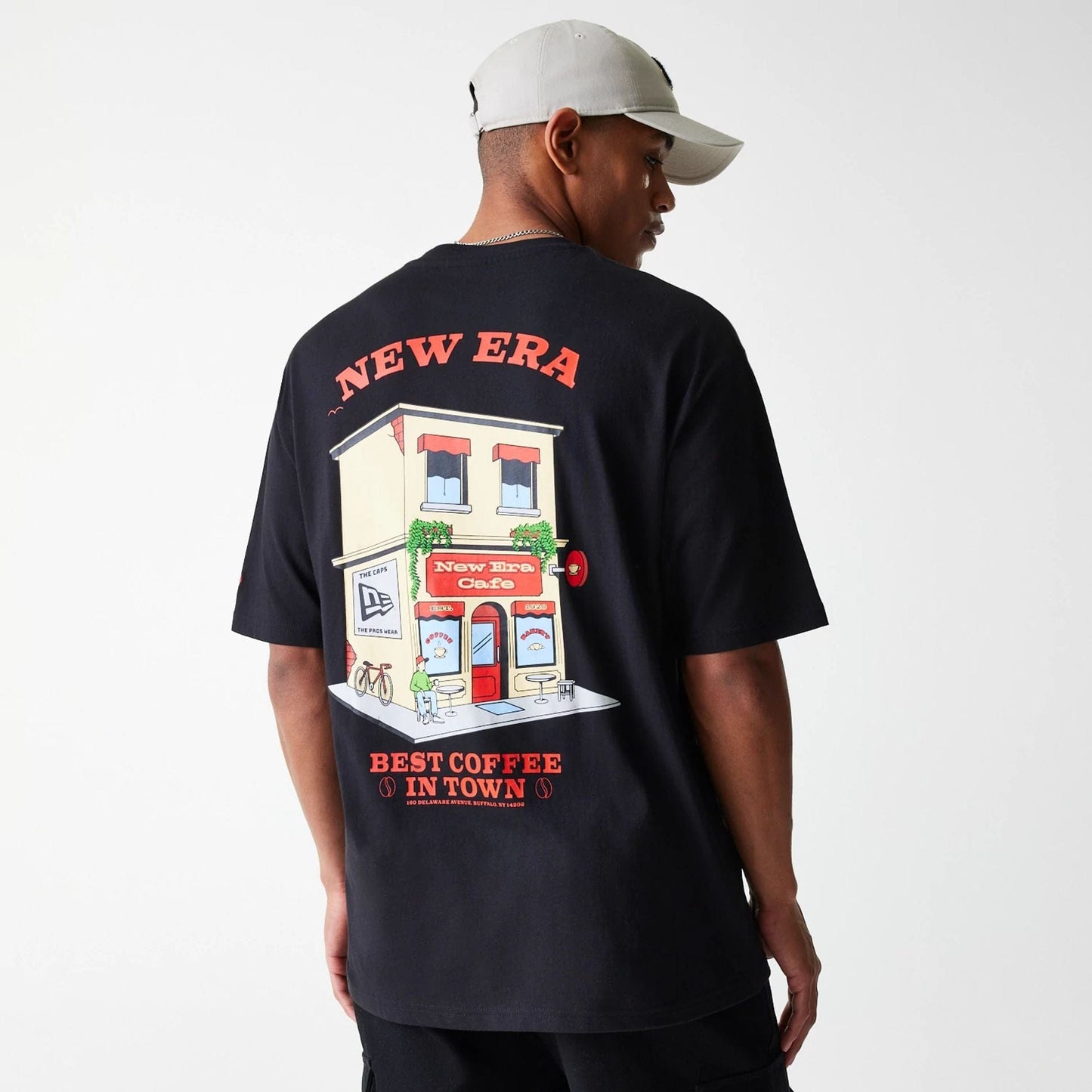 The Male model is wearing New Era Cafe Graphic Black Oversized T-Shirt 4